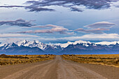 Panoramic view of the Cordillera de los Andes before sunrise along a gravel road with spectacular clouds, Argentina, Patagonia, South America
