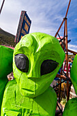 Wooden sculpture of little green alien characters. in New Mexico.