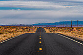 Road leading through the Navajo nation in the Arizona desert.