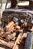 Rusted oldtimer car wreck left behind in a field.