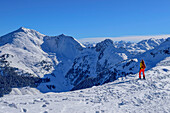 Woman on ski tour looking at Großer Galtenberg, from the Wiedersberger Horn, Kitzbüheler Alpen, Tirol, Austria