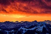 Glowing red clouds after sunset with a view of Col Nudo and Monte Sernio, from Dobratsch, Gailtal Alps, Carinthia, Austria