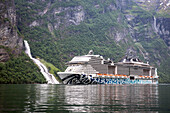 Cruise ship MSC Euriba under the waterfall in Geiranger Fjord, name Freier, belongs to the saga of the 7 sisters, Hellesylt, Unesco World Heritage Site, Fjord, Moere and Romsdal