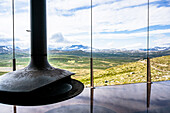 Interior view with fire pit and view at Snoehetta Viewpoint, Hjerkinn, Dovre, Visitor Center wild Reindeer, Dovrefjell-Sunndalsfjella National Park, Tverrfjellhytja, Oppland Region, Norway