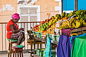 Market woman with colorful fruit at the Praia market on the island of Santiago de Cabo Verde, Cape Verde