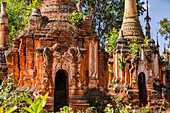 Pagodas and stupas in the Buddhist cemetery of the impressive In-Dein Pagoda Forest on Inle Lake in Myanmar