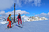 Two women on a ski tour stand at the summit of Kuhmesser, Kellerjoch in the background, Kuhmesser, Tux Alps, Tyrol, Austria