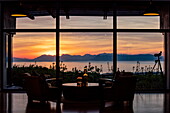 Forest Lodge lounge overlooking Walker Bay and the mountains of Maanschynkop Nature Reserve at sunset, Grootbos Private Nature Reserve, Western Cape, South Africa