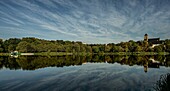 Castle pond park in Chemnitz, Café Milchhäuschen and castle church in the morning light, Saxony, Germany