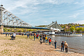 Historic steamship and spectators during the 2023 Steamboat Parade in front of the Blue Wonder Bridge of Dresden, Saxony, Germany