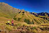 Man and woman hiking up to Organ Pipes Pass, The Pyramid in the background, Didima, Cathedral Peak, Drakensberg, Kwa Zulu Natal, UNESCO World Heritage Site Maloti-Drakensberg, South Africa