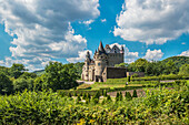 Bürresheim Castle amidst a lush garden, Rhineland-Palatinate, Germany