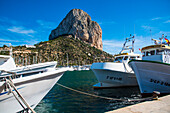 Calpe, fishing boats in the fishing harbor, with the steep walls of the Penon de Ifach, the landmark of Calpe, Costa Blanca, Spain