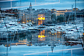 Doppelbelichtung des Yachthafen von Marseille in der Abenddämmerung.