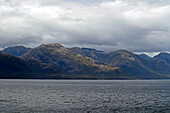 Chile; Southern Chile; Aysen region; Mountains of the southern Cordillera Patagonica; on the Navimag ferry through the Patagonian fjords; Canal Messier; Rain clouds over the mountain landscape