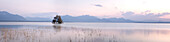 Panoramic view of Chiemsee with tree island at sunset, Chiemsee, Bavaria, Germany, Europe