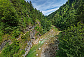 Two people hiking on Klammsteig high above the Brandenberger Ache, Tiefenbachklamm, Rofan, Tyrol, Austria