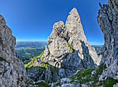 Panorama with woman hiking in Kleiner Törl and Törl towers, from Kleiner Törl, Kaisergebirge, Tyrol, Austria