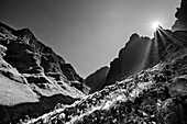 Sun peaks over rocky peaks in mountain valley, Rhino Peak, Garden Castle, Drakensberg, Kwa Zulu Natal, UNESCO World Heritage Site Maloti-Drakensberg, South Africa