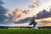  Radio telescope of the Raisting earth station in front of picturesque storm clouds, Raisting, Upper Bavaria, Bavaria, Germany 