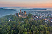  Aerial view of Braunfels castle and palace, castle towers Hubertusturm, Neuer Bergfried, Georgturm and Alter Stock at sunrise, Braunfels, Lahn, Westerwald, Lahntal, Taunus, Hesse, Germany 