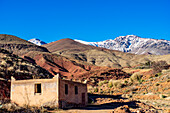  Morocco, empty clay house in front of the Altlas Mountains 