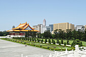  Pagoda buildings on the grounds of the Chiang Kai-shek Memorial in Taipei, Taiwan, with high-rise buildings in the city center in the background 