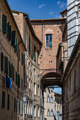 Typische Häuserzeile in der Altstadt mit Wäscheleine und Stadttor, Siena, Region Toskana, Italien, Europa
