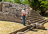 Surveyor at work, Temple of Panels, Templo de los Tableros Esculpidos, Chichen Itzá, Mayan ruins, Yucatan, Mexico