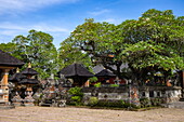  Stone carvings and sculptures and trees at Pura Puseh Desa Batuan Hindu Temple, Denpasar, Bali, Indonesia 