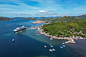  Aerial view of boats and houses along the coast and cruise ship Vasco da Gama (nicko cruises) at the pier, Coron, Palawan, Philippines 