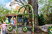 Bunny school and decorated Easter fountain at the village square of Ottenhofen in Upper Bavaria in Germany 
