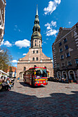  St. Peter&#39;s Church, considered the cradle of the Reformation in the Baltic States, in front of it a bus for sightseeing tours, Riga, Latvia 