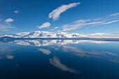  Mountain landscape reflected in the glacier lake Joekusarlon, winter, Iceland 