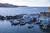  Fishing boats and colorful boat garages in the fishing village of Mandrakia, Milos, South Aegean, Greece, Europe 