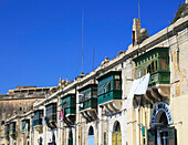 Old merchant house with balcony above warehouse area, Valletta, Malta