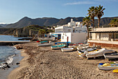 Small boats dinghies on sandy beach at Isleta del Moro, Cabo de Gata natural park, Almeria, Spain