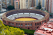 Historic bullring in city of Malaga surrounded by high rise apartments, Malaga, Andalusia, Spain