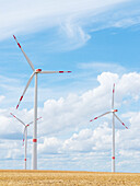  Wind turbines against a blue cloudy sky, Alzey, Rhineland-Palatinate, Germany 