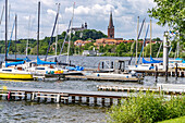  Sailing school on the Great Plön Lake, St. Nicholas Church and Plön Castle in Plön, Schleswig-Holstein, Germany  