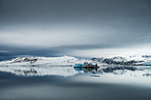  View of snow-capped mountains and an iceberg in the Isfjord, Spitsbergen, Svalbard, Norway, Arctic 