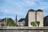  View of buildings in the harbor of Copenhagen. In the background the Church of Our Savior in the Christianshavn district, Copenhagen, Denmark 