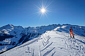  Woman on ski tour ascending to Standkopf, with view to Großer Beil, Standkopf, Kitzbühel Alps, Tyrol, Austria 