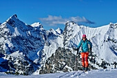  Woman on ski tour ascending to Bärenkopf, Sonnjoch and Schaufelspitze in the background, Bärenkopf, Karwendel, Tyrol, Austria 