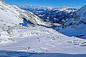  Woman on ski tour descends through Kirtagskar, Arzlochscharte, Totes Gebirge, Upper Austria, Austria 