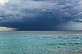 Heavy rain falling dark storm cloud above Ionian Sea, offshore from Dhermi, Albania, Europe