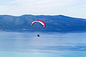 Paraglider taking off from mountainside above the Adriatic Sea at Vlore, Albania, Europe