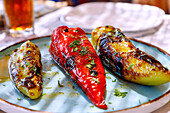  grilled stuffed pointed peppers (Piperies Florinis) with mixed salad, served in the tavern in Emborió on the island of Kalymnos in Greece 