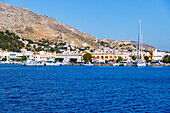  Island capital Póthia, customs and port office, nautical museum, town hall (Dimarchio) and boats in the harbor on the island of Kalymnos (Kalimnos) in Greece 