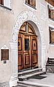   Traditional house in Valchava with sgraffito on the facade and around wooden doors and windows, Graubünden, Switzerland 